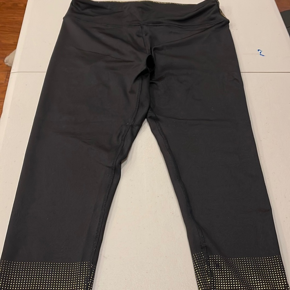 Women’s size Medium, Venus leggings. Black and gold